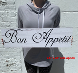 Bon Appetit Sign held up