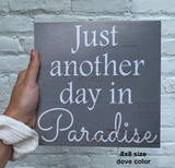 Paradise Sign Held